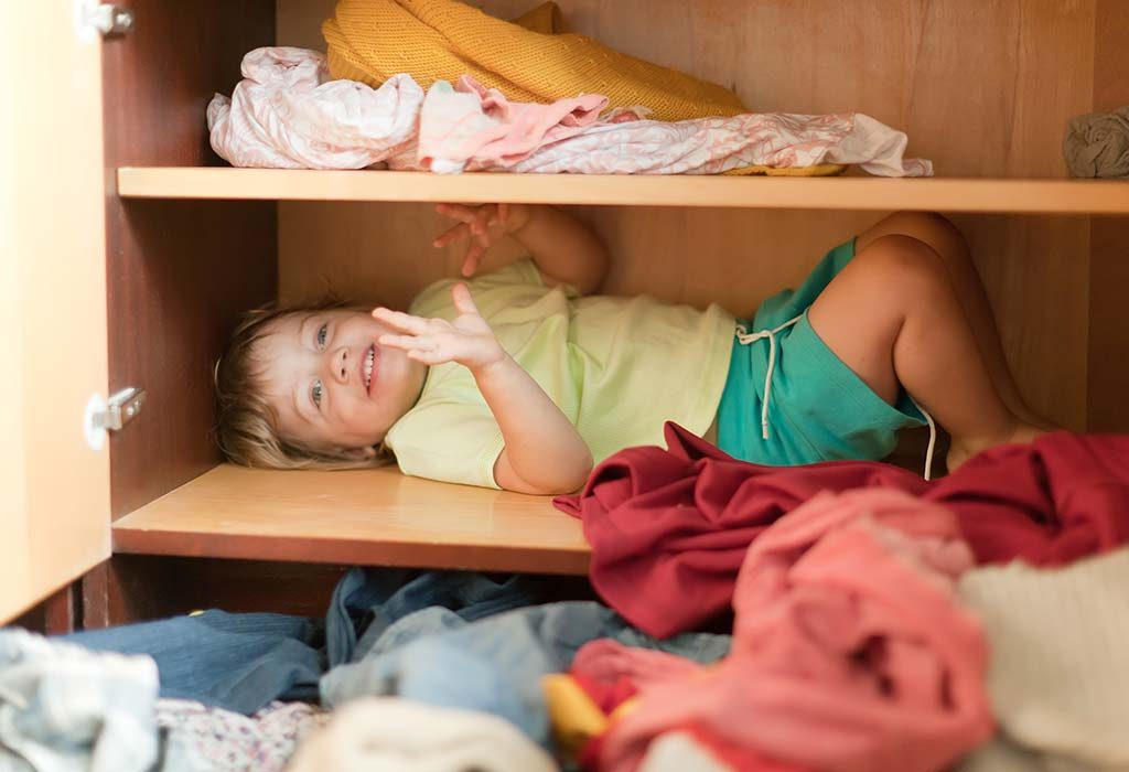 baby hiding in a closet to pull a prank on parents