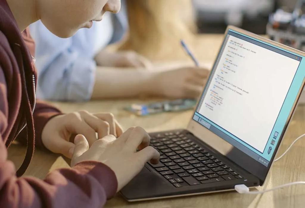 A school going boy working on a laptop