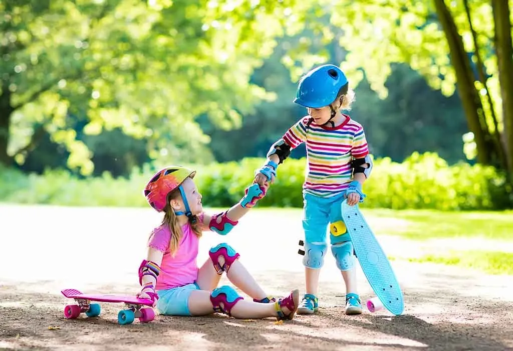 A little girl helping another girl