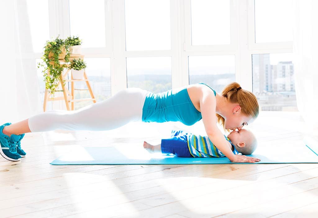 A woman exercising with her baby