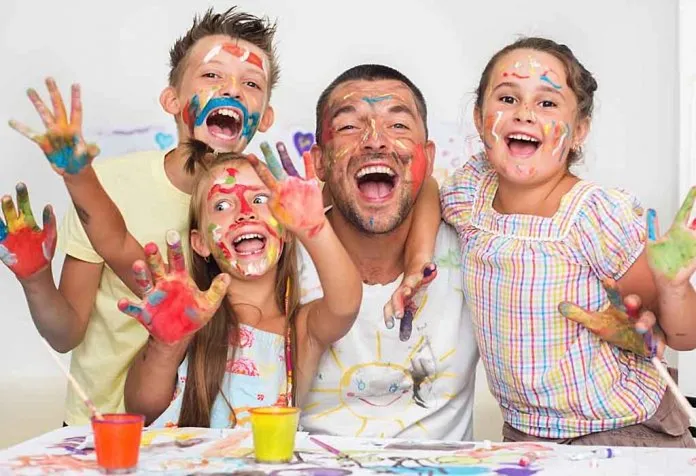 colour-stained family enjoying tie-dye activity