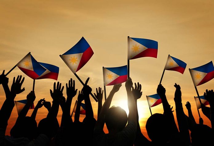 people waving the National flag of Philippines