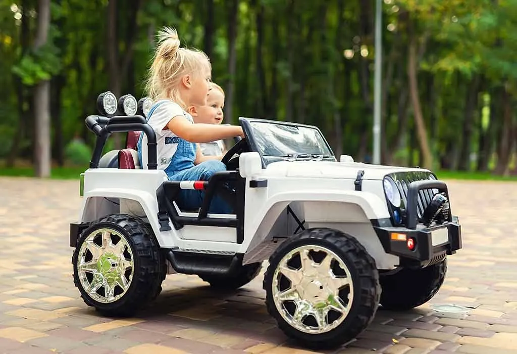 kids riding an electric toy car
