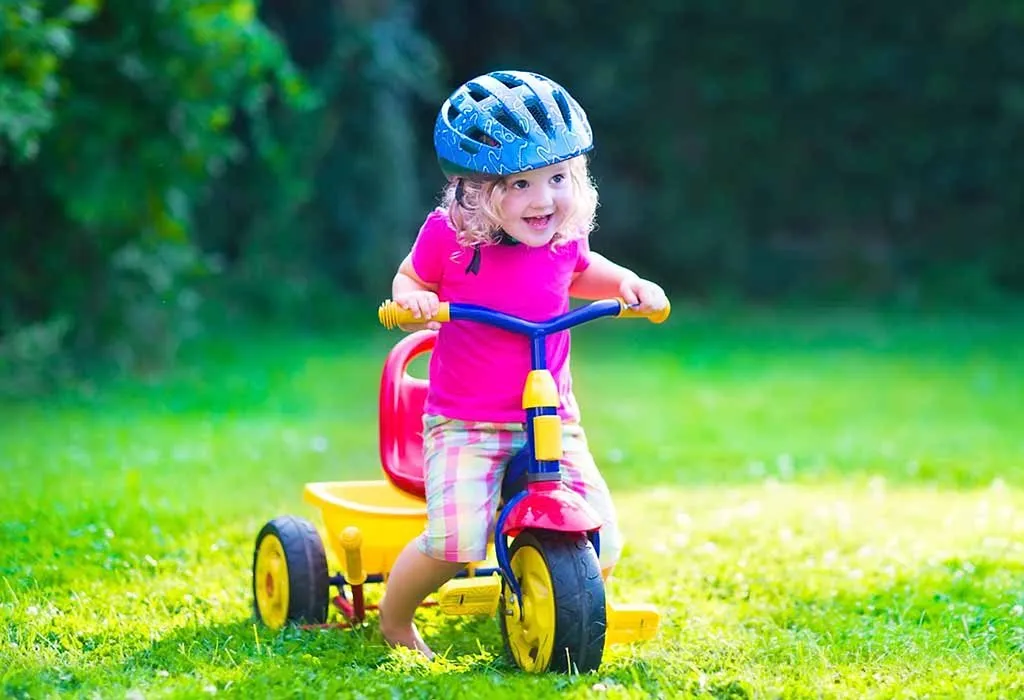 girl riding a tricycle