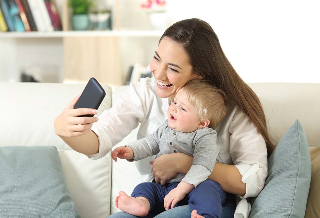 A social baby video chatting with mom