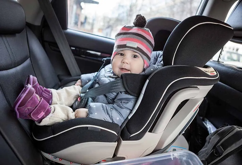 A toddler sitting in a rear-facing car seat