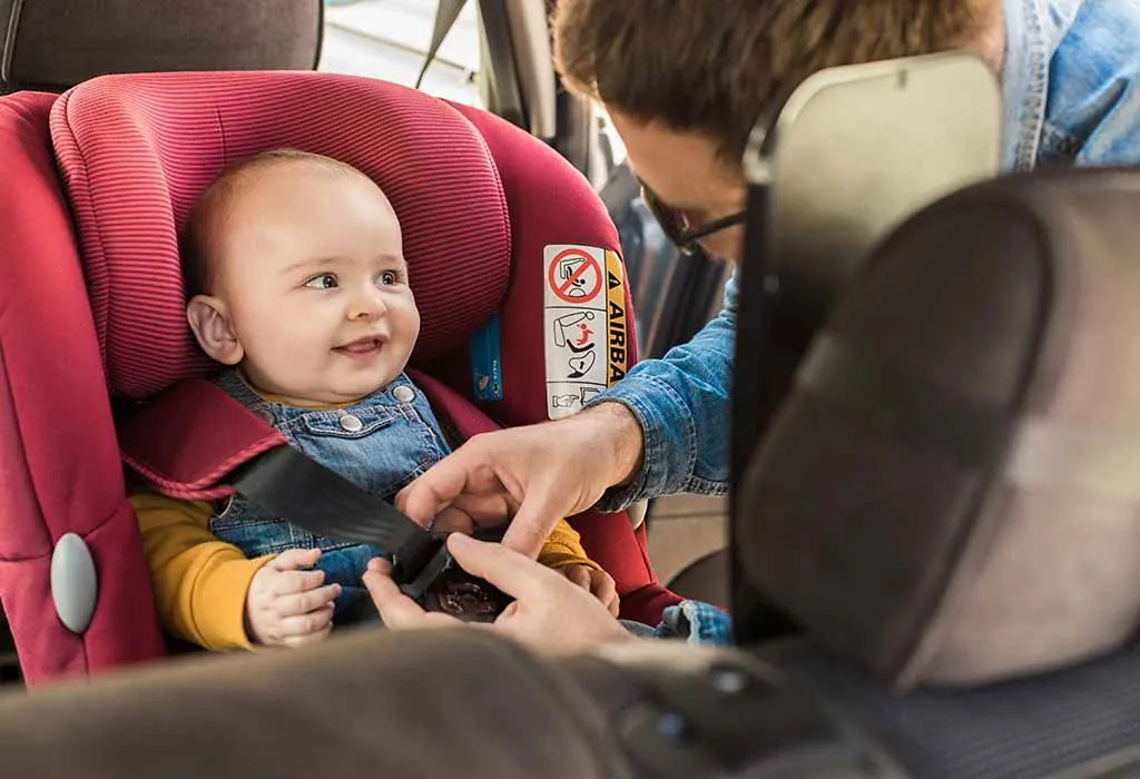 A parent checking the safety harness in a car