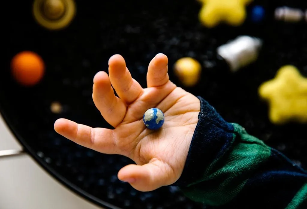 child playing in a sensory bin