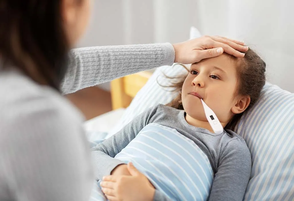 mom taking child’s oral temperature