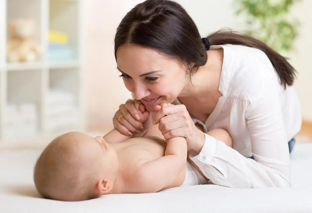 mother massaging baby