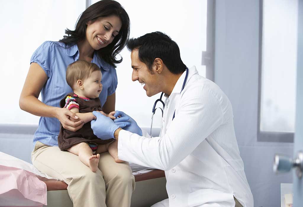 A baby with her parents at doctor's