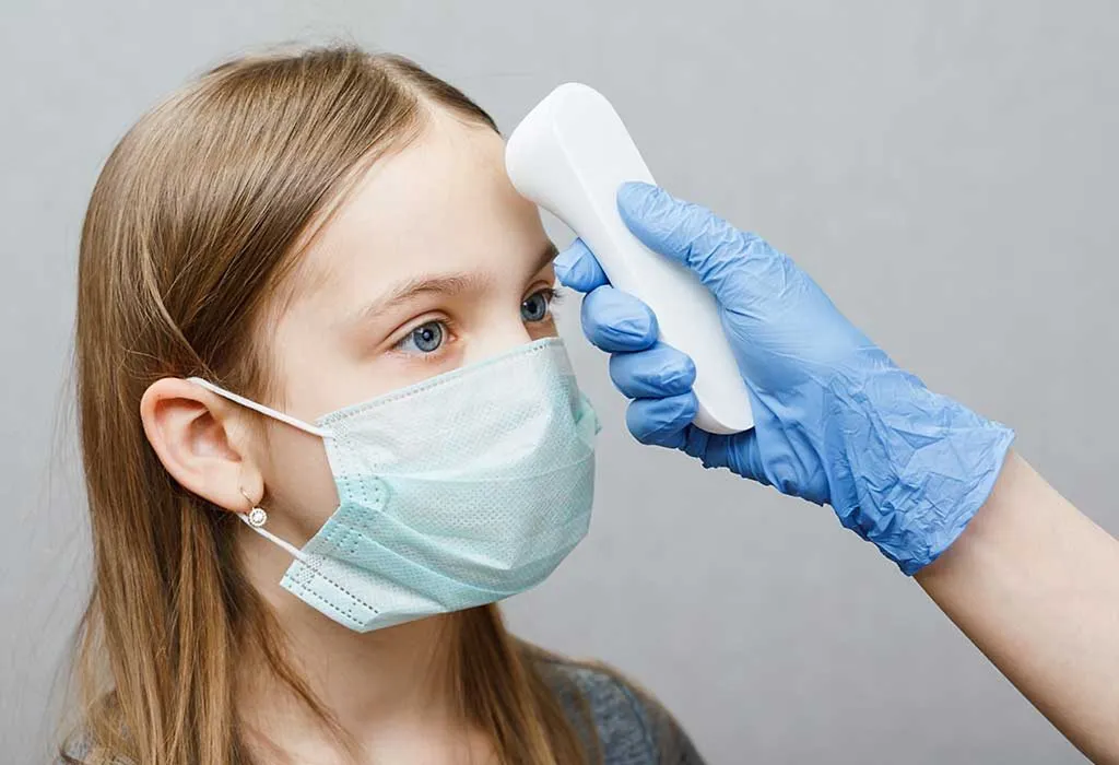 doctor taking child's temperature