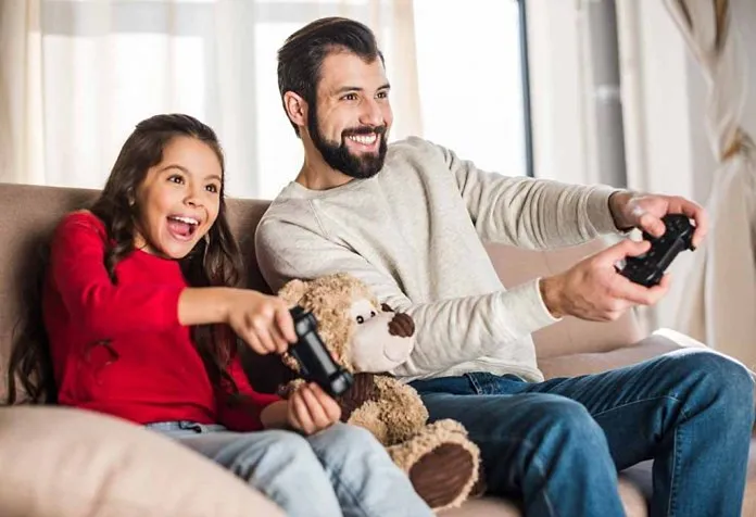 father and daughter enjoying a split-screen game
