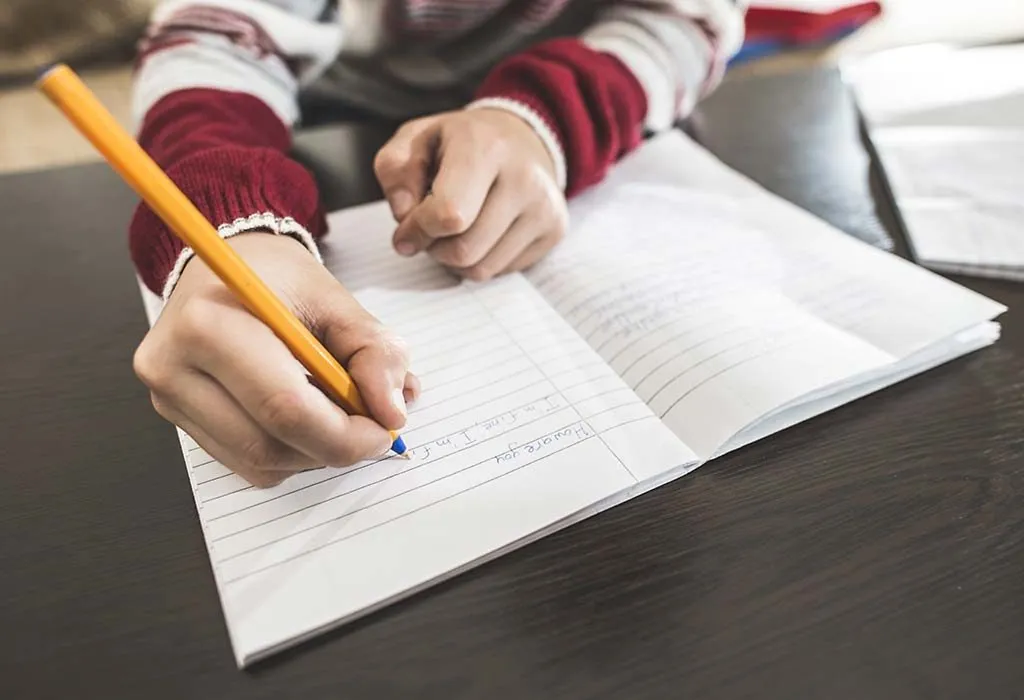 child writing in a notebook