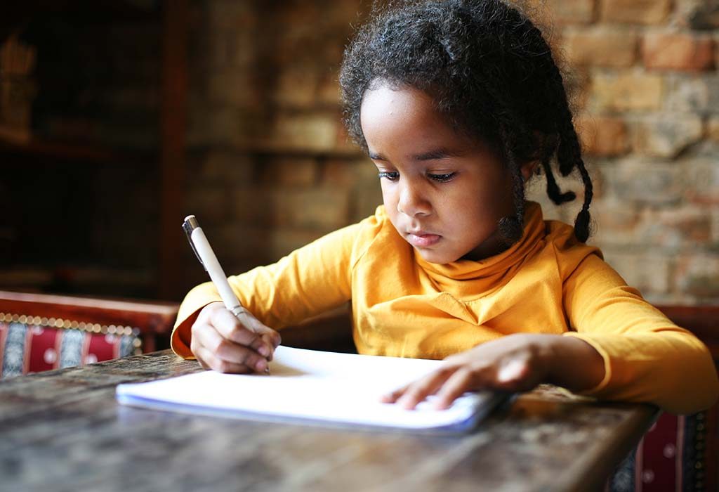 child writing an essay at home