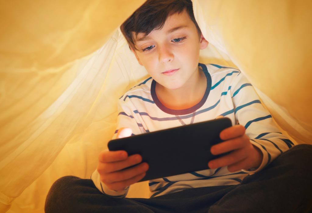 boy playing game on tablet
