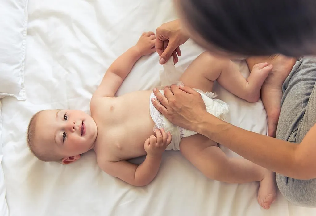 mother changing baby's diaper