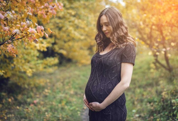 expecting mom having a silent word with her unborn baby