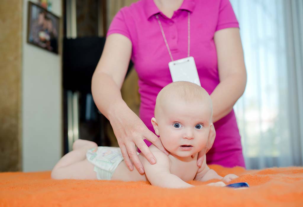 doctor examining 4-month baby