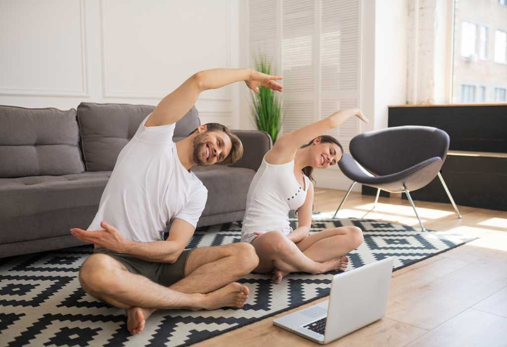 A couple practising yoga at home