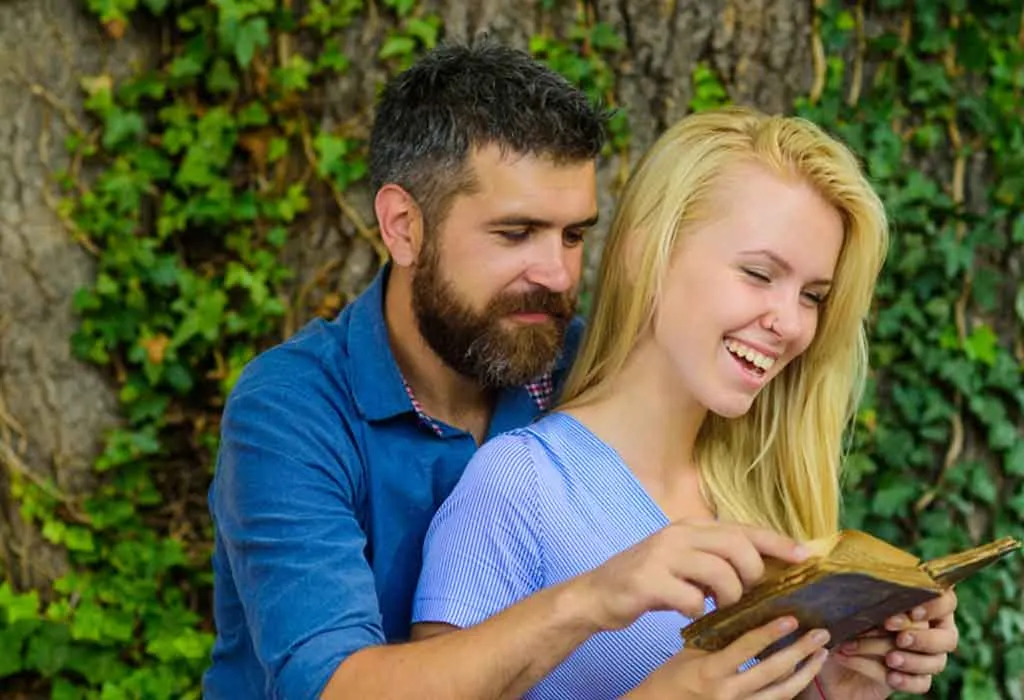 Older married couple playing laughing husband grabbing wifes boobs