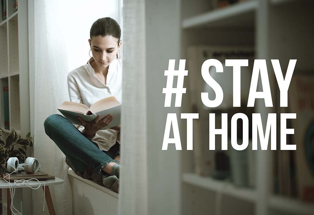 A woman in home isolation reading a book and #stayathome