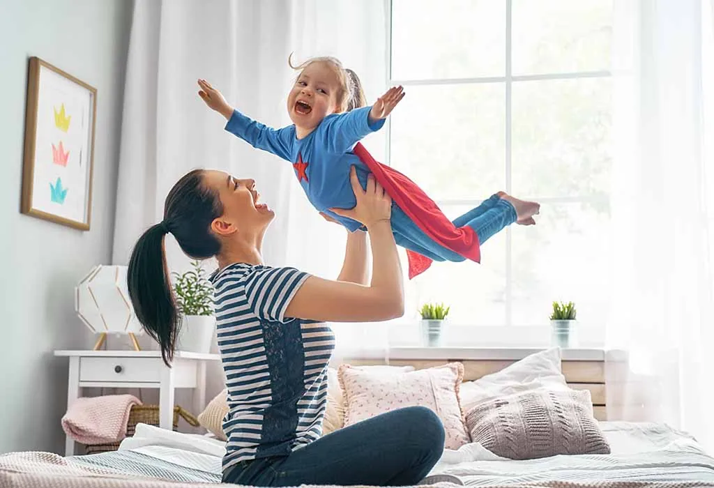 Happy Mother and Baby Playing and Laughing
