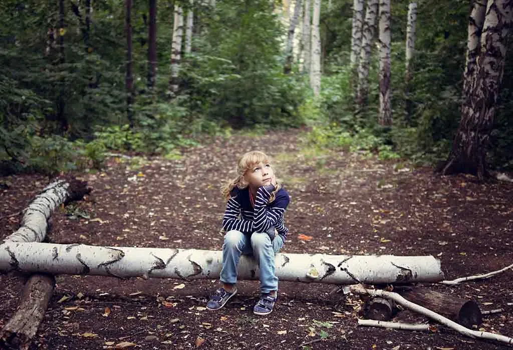Girl sitting in woods 