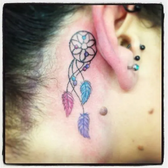 Dreamcatcher tattoo behind the left ear