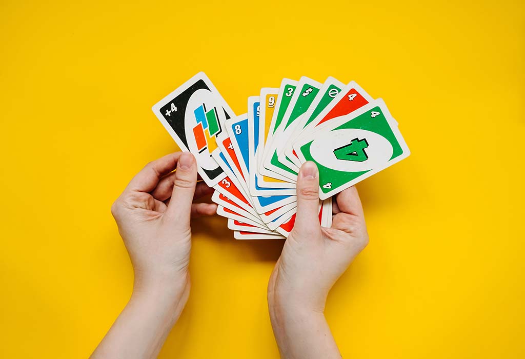 Playing American Card Game Uno, Holding Game Cards in Female Hand