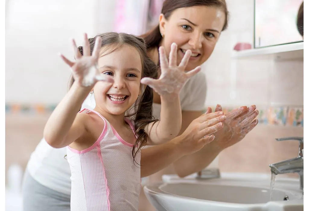 Mother and daughter washing hands together