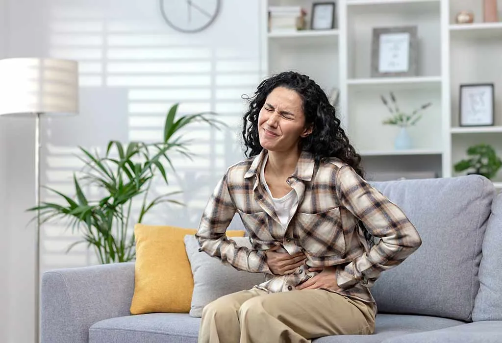 A lady experiencing severe or prolonged Pain in stomach