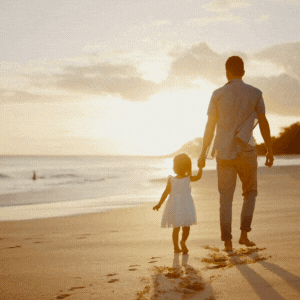 father child walking on beach