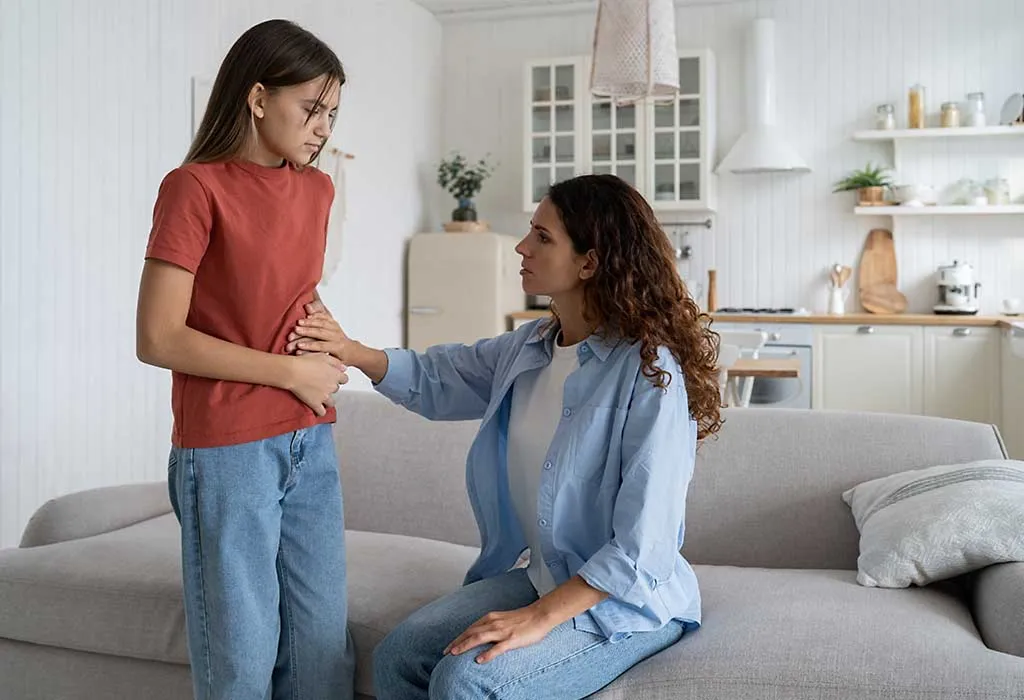 Girl having cramps and showing it to her mom